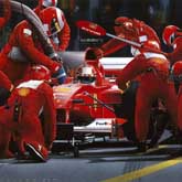 Scuderia Ferrari pit crew undertaking a pit-stop on Michael Schumacher's Ferrari at the United States Grand Prix.